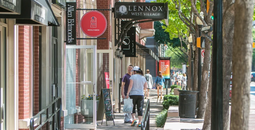 Shoppers walking along the storefronts in West Village, a popular shopping destination in Dallas.