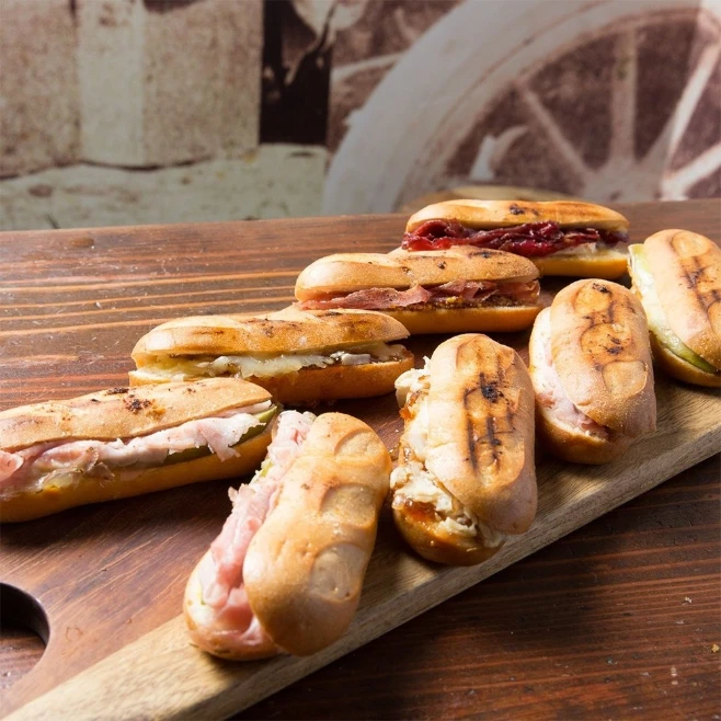 Assorted mini sandwiches on a wooden board at a restaurant in Downtown Las Vegas.