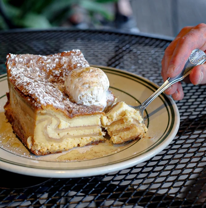 Slice of tiramisu with a dollop of cream on a plate at an outdoor restaurant in Las Vegas